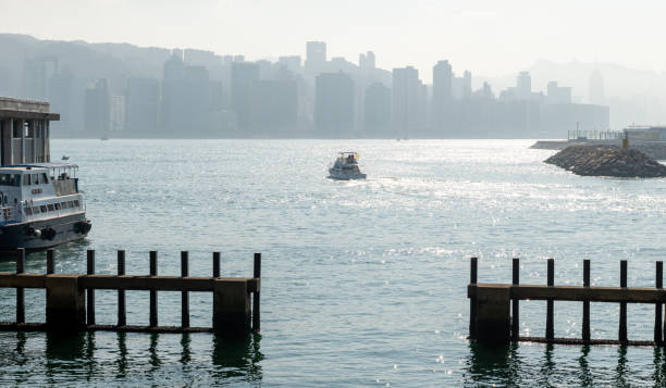 Hong Kong. China- 02.15.2025. The Kwun Tong Ferry Pier in East Kowloon with a boat leaving for Hong Kong island.