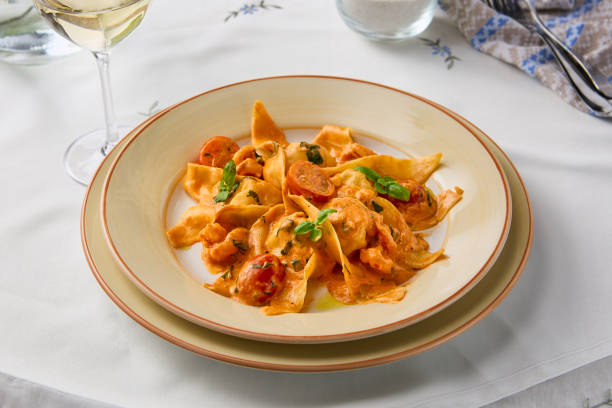 istock Creamy Tomato Shrimp Pasta in Elegant Dinner Setting 2204189159