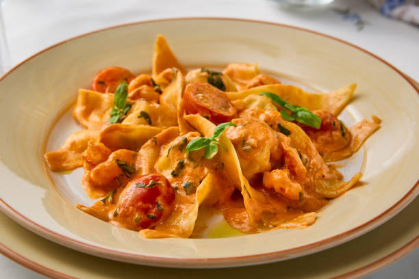 istock Creamy Shrimp and Tomato Pasta in Soft Lighting with Warm Tones 2204189639