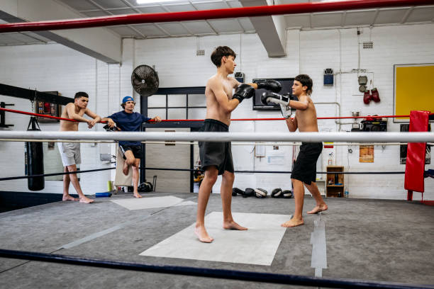 istock Youth club boxers: Shirtless, barefoot, and sparring 2204191385