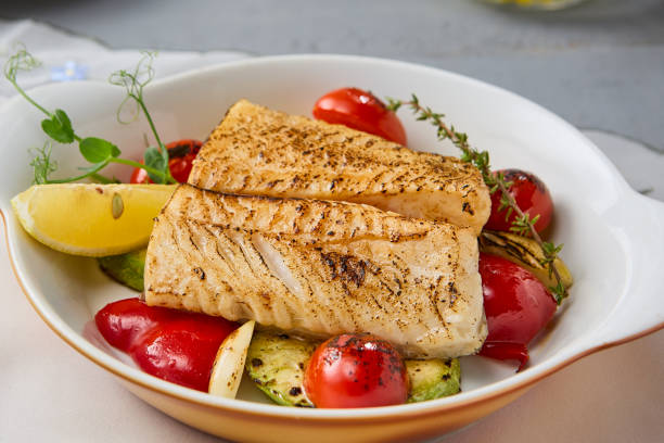istock Grilled Cod Fillet with Tomatoes and Zucchini A Vivid Culinary Delight 2204192412