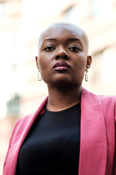 istock Young businesswoman posing with a serious expression in urban background 2204192465