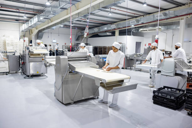 istock Group of workers working in the production line at an industrial bakery 2204192524