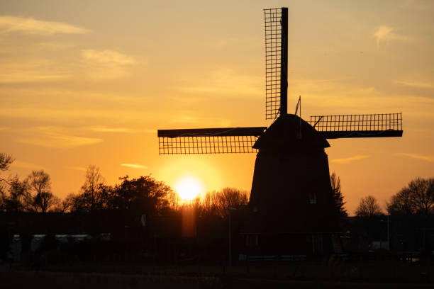 istock Windmill against a golden sunset 2204193750