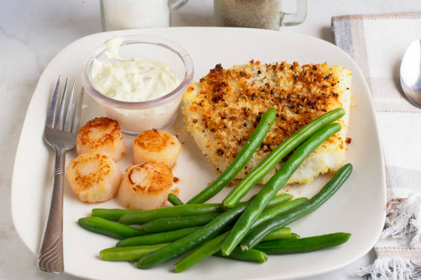 istock baked haddock served with scallops and green beans 2204193859