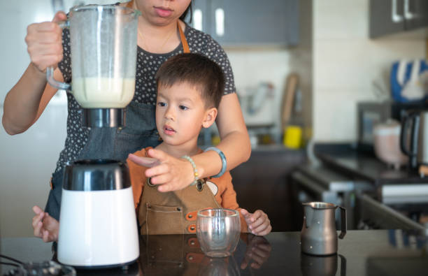 istock Mother and Child Enjoying Kitchen Smoothie Time 2204193890