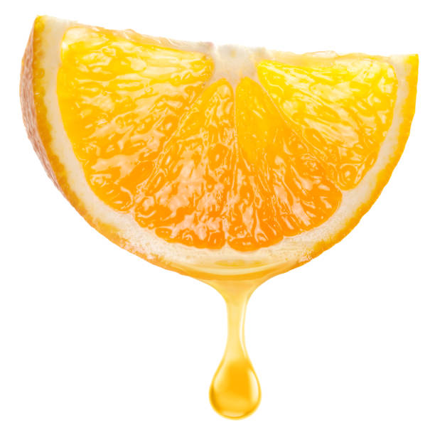 istock Slice of orange fruit and orange juice dripping from it on a white background. File includes clipping path. 2204196174