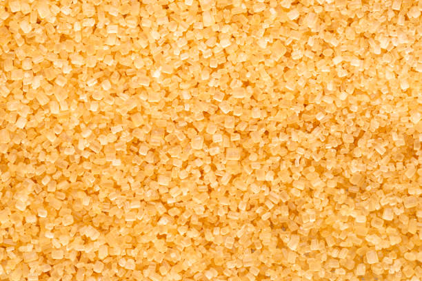 istock Brown cane sugar crystals  close up. Food background. 2204196307
