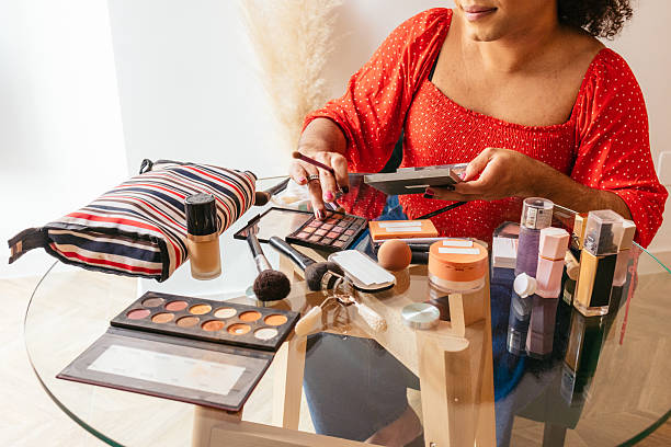 istock Transgender influencer applying makeup using a palette and various cosmetics 2204198151
