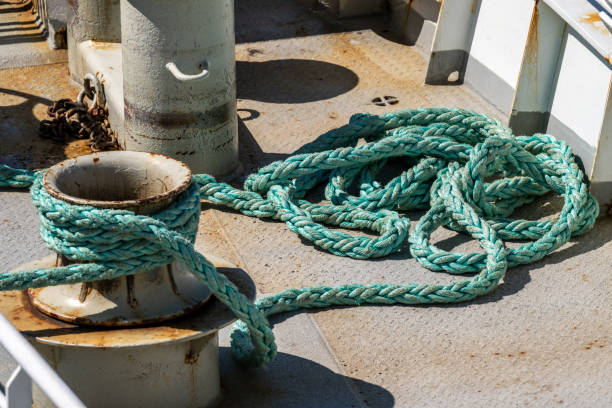 istock coiled green mooring rope on weathered ship deck.. 2204199689