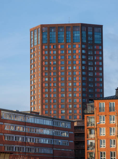istock tall brick highrise with reflective windows.. 2204199725