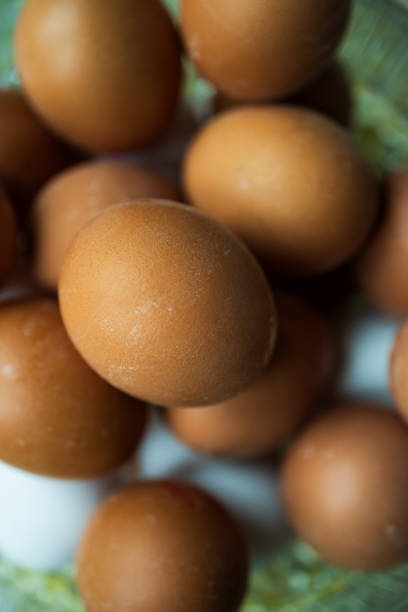 Close-up of fresh brown eggs in basket.