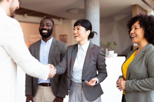 istock Office team applauding a happy colleague 2204200041