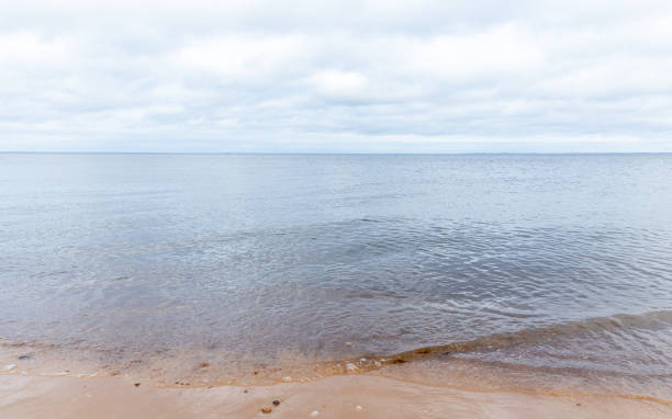 istock A serene sea horizon is gently meeting a sandy shore 2204200967