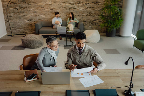 istock Professional Colleagues Collaborating in a Modern Office Environment for Project Planning 2204206249
