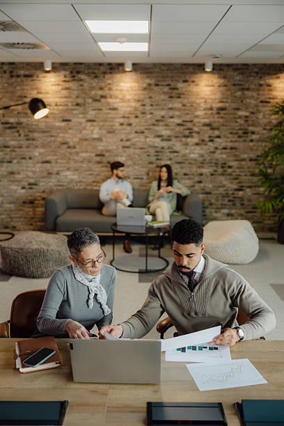 istock Professional Team Collaborating in Contemporary Office Environment With Colleagues in Background 2204206277