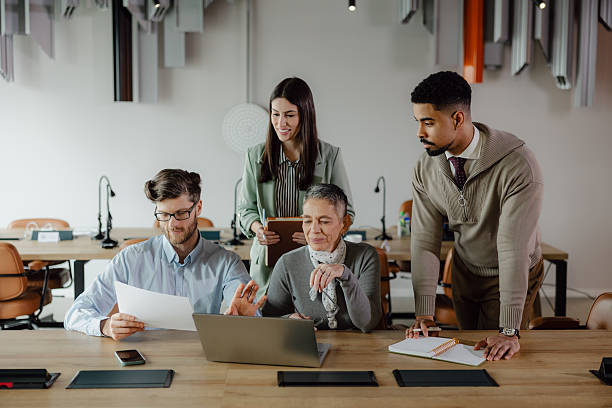 istock Team Collaborating Around a Laptop in a Modern Office Space 2204206709