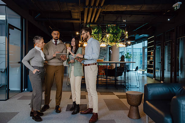 istock Group of Professionals Collaborates in a Modern Office Environment 2204211579