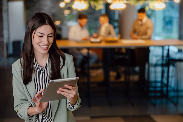 istock Professional Woman Using Tablet During Business Meeting in a Modern Office 2204211696