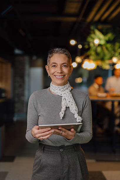 istock Confident Professional Woman Holding Tablet in Modern Office Environment 2204211832