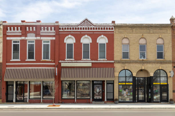 The storefront on a historic building with orange details and a green door in Council Bluffs, Iowa
