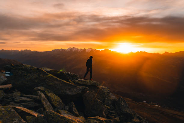 istock Hiker explores mountain ridge at sunrise 2204219153