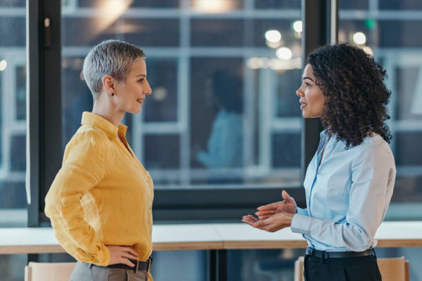 istock Coworker friendly talk in the office 2204219219