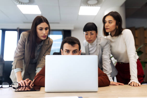 istock Business team looking at the laptop computer while working in the office 2204220550