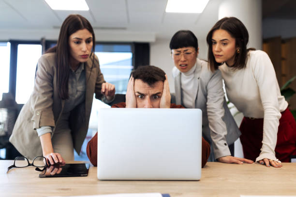 istock Business team looking at the laptop computer while working in the office 2204220614
