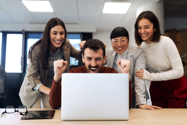 istock Business team looking at the laptop computer while working in the office 2204220650