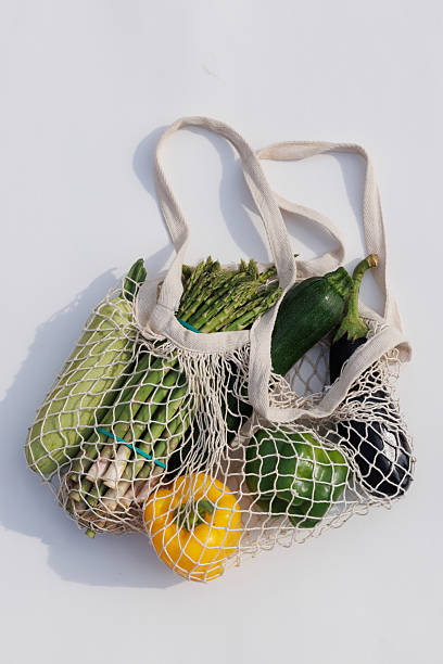 istock Fresh assorted vegetables in an eco-friendly woven bag, ready for a healthy and sustainable meal 2204223343