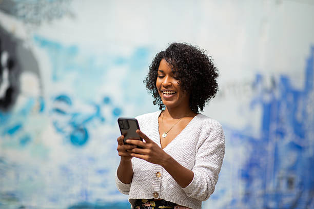 istock young woman looking at mobile phone 2204226937