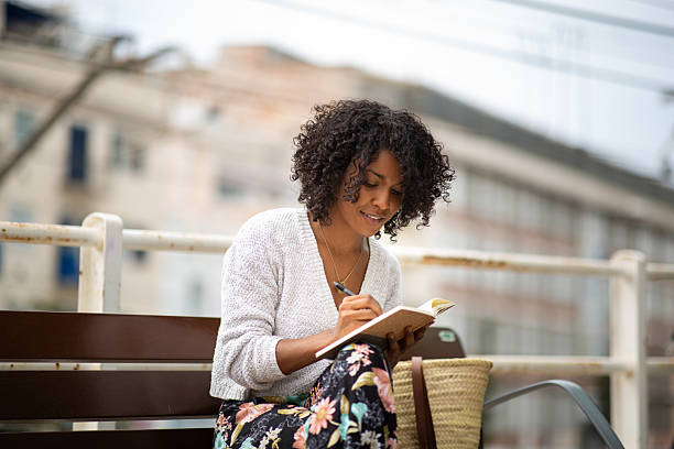 istock young african american woman writing in book 2204226986