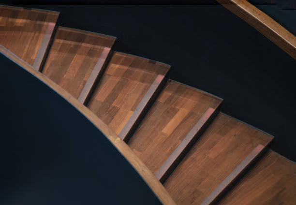 istock Layered wood spiral stairs with railings handle grip interior. 2204228059