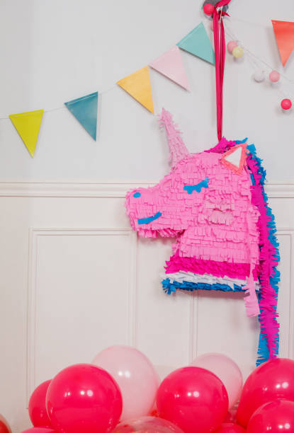 istock Celebration decor with vibrant unicorn pinata and colorful flags 2204228690