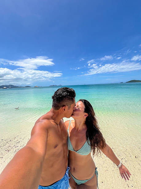 istock Couple Enjoying a Romantic Beach Day with Clear Blue Waters 2204231949
