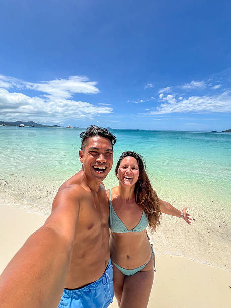 istock Couple Taking a Selfie on a Tropical Beach 2204232121