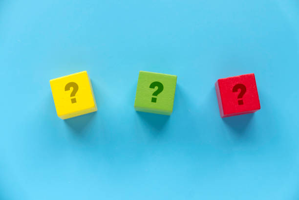 istock Colorful Wooden Blocks with Question Marks on Blue Background 2204235310