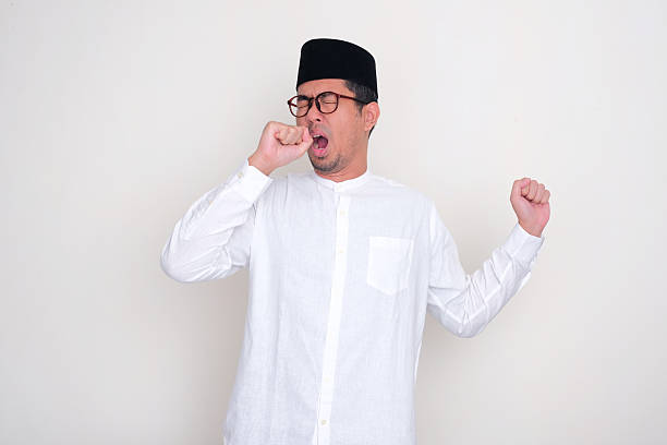 istock Muslim man yawning sleepy during fasting month 2204235955
