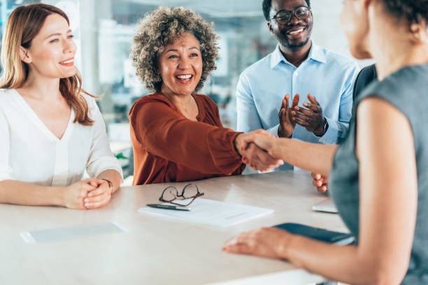 istock Shaking hands with new colleague 2204237511