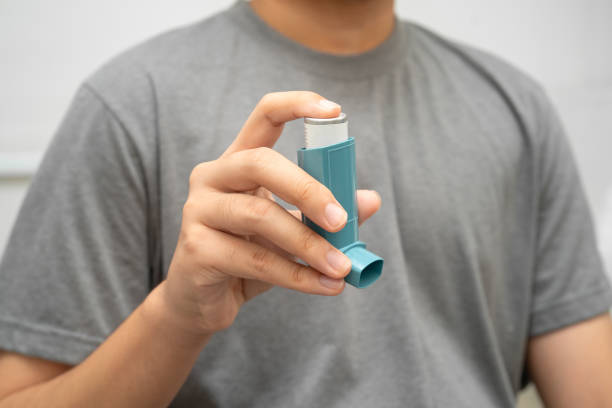 istock Asthma and chronic obstructive pulmonary disease COPD, Asian young man using metered dose inhaler MDI. 2204243557