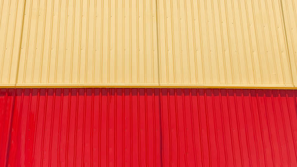 istock Corrugated fence,Colorful diagonal patterned backdrop featuring a wall display of corrugated steel polymer coated panels for construction material samples 2204244569