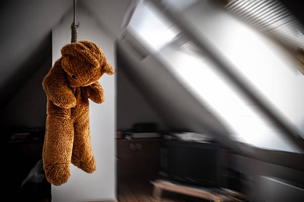istock A teddy bear hanging in a noose in the attic room 2204246965