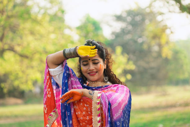 istock A beautiful girl celebrating holi with colours 2204247387