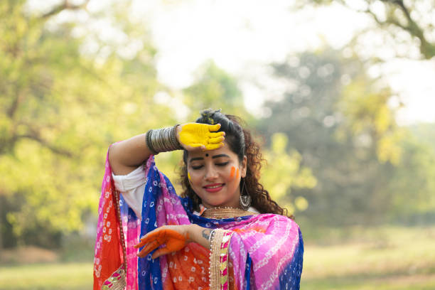 istock A beautiful girl celebrating holi with colours 2204247389