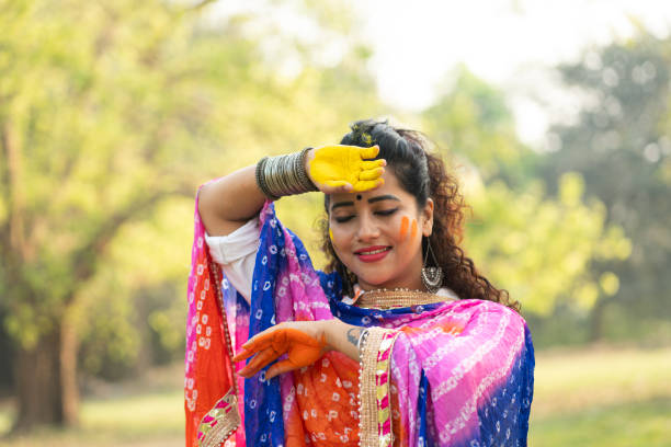 istock A beautiful girl celebrating holi with colours 2204247390