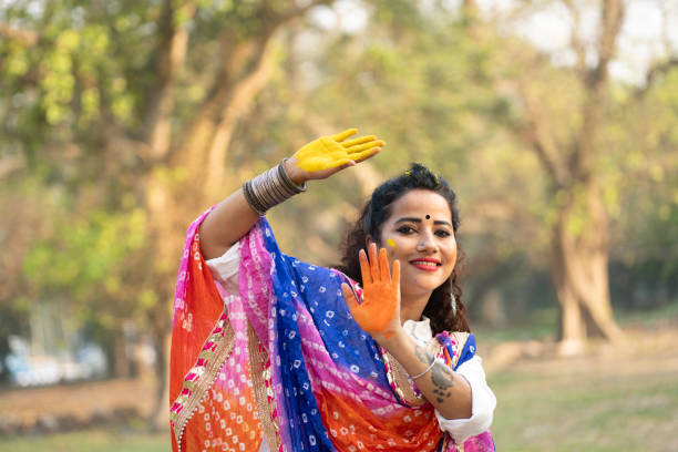 istock A beautiful girl celebrating holi with colours 2204247405