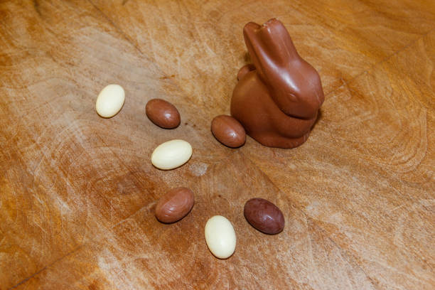 Chocolate Easter eggs and rabbit on rustic wooden background