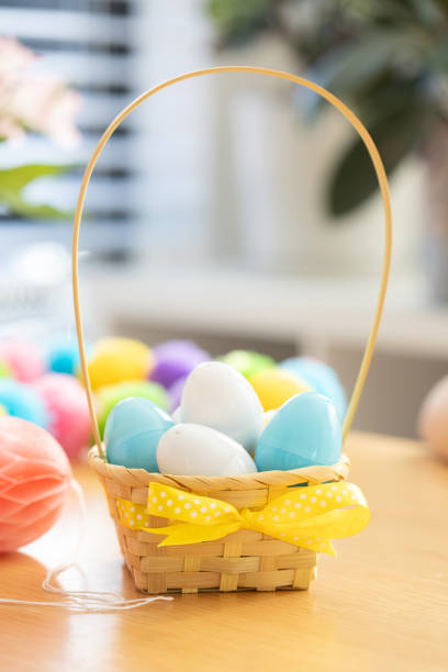 istock Colorful plastic eggs with candies inside in a basket. Egg hunt. Happy Easter 2204249259
