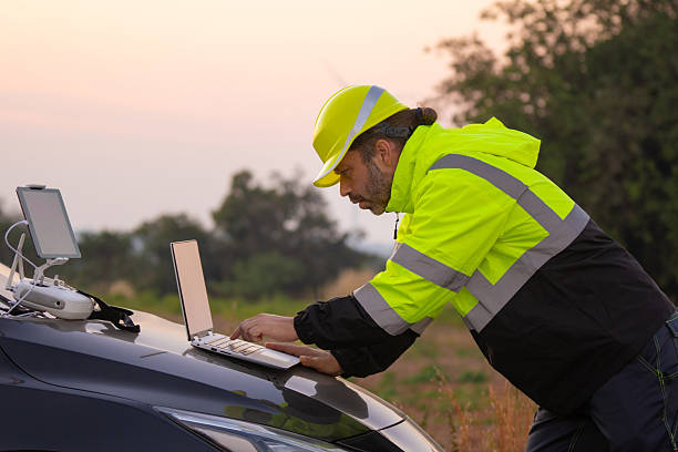 istock Engineer working on laptop checking wind turbines of the field. 2204250631
